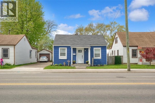 Side view of the blue house showing the driveway and adjacent garage. - 14 Mcnaughton Avenue, Wallaceburg