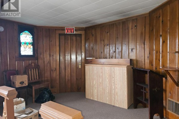 Interior room with wood paneling, stained glass window, and wooden furniture. - 14 Parkwood Lane, Temagami