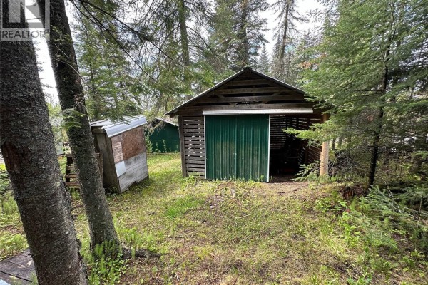 Wooden shed with a green sliding door next to a smaller shed. - 14 Parrhill Street, Hudson Bay Rm No  394