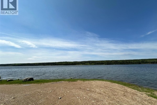 Wide view of a calm lake with a tree line and blue sky. - 14 Parrhill Street, Hudson Bay Rm No  394