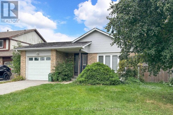 Side view of the front exterior of a single-family home with a stone and siding facade, attached garage, and green lawn. - 14 Pilkington Crescent N, Whitby