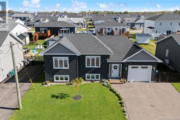 Aerial view of a dark grey siding house with a white garage door. - 14 Robert Street, Shediac
