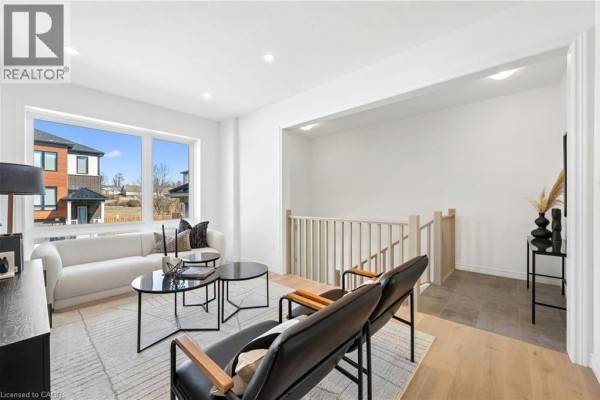 Living room with large windows, modern furniture, and open layout. - 14 Sora Lane, Guelph