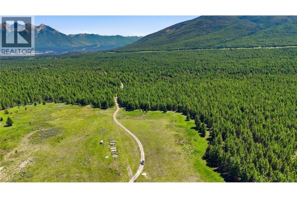 Aerial shot of a winding dirt road through a forest clearing, with some structures visible. - 14 Sub Lot 3/93 Highway, Cranbrook