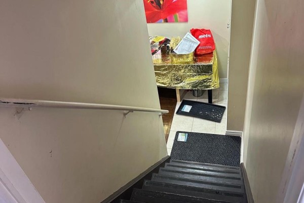 Wooden staircase with a white handrail leading down to a landing with a table. - 14 Whitbread Crescent, Ajax