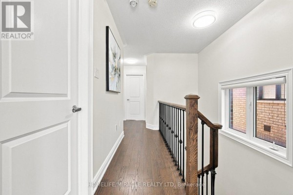 Hallway with hardwood floors, modern railing, and artwork - 14 Zenith Avenue Vaughan
