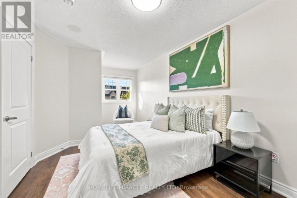 Bedroom with tufted headboard and abstract art - 14 Zenith Avenue Vaughan