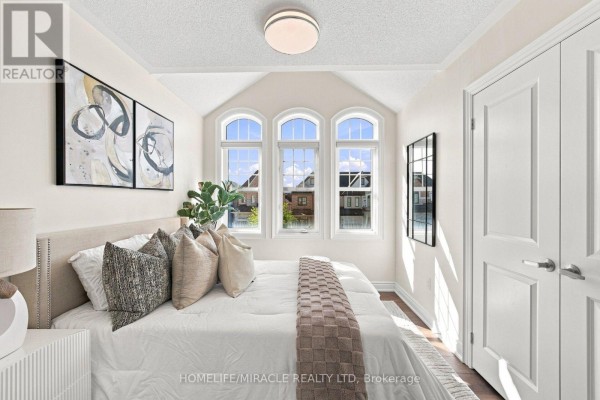 Bedroom with arched windows, vaulted ceiling, and art - 14 Zenith Avenue Vaughan