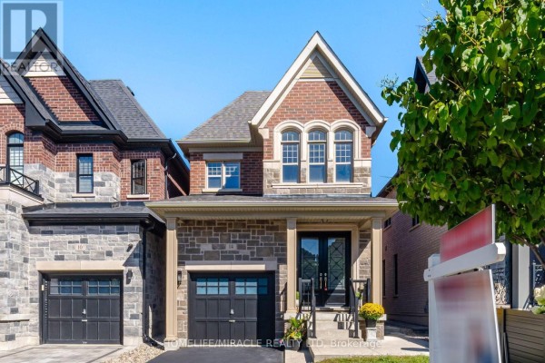 Modern house with stone and brick facade, double garage and arched windows - 14 Zenith Avenue Vaughan