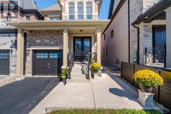 Modern house with stone facade, garage, and double doors - 14 Zenith Avenue Vaughan