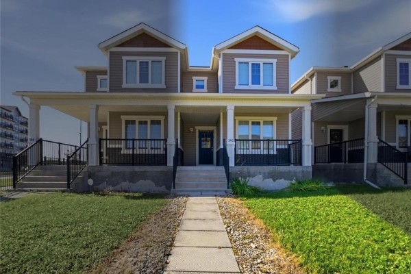 Front exterior of a beige townhouse with a covered porch and grass lawn. - 140 Park East Drive, Winnipeg