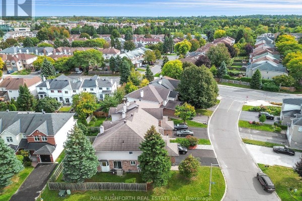 Aerial view of townhouses in a suburban neighborhood with streets and trees. - 140 Thornbury Crescent, Ottawa