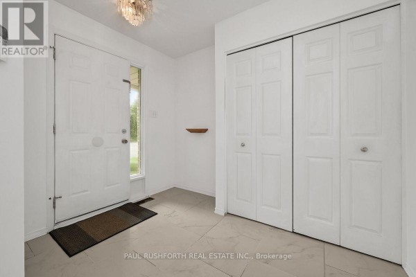 Interior entryway with white doors, a closet, and tiled flooring. - 140 Thornbury Crescent, Ottawa