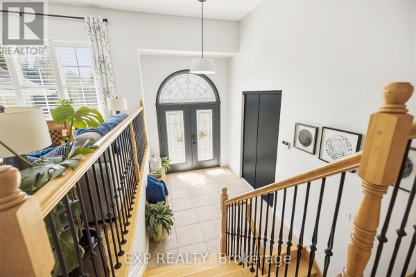 View from the top of the stairs looking down at the foyer and front door. - 140 Windmill Crescent, Beckwith