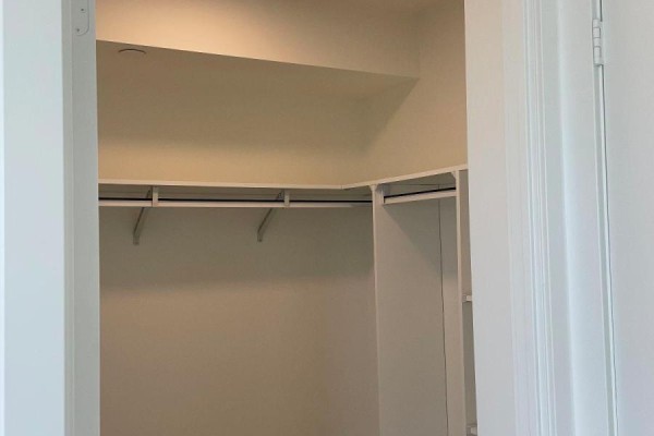 Walk-in closet with built-in shelves and hanging rods. - 1401 - 10 Wilby Crescent, Toronto
