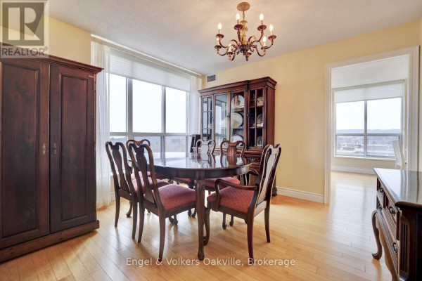 Formal dining room with wood table, chairs, china cabinet, and chandelier - 1402 - 442 Maple Avenue Burlington