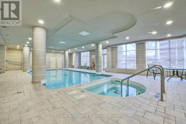 Indoor pool and hot tub with tiled floors and seating - 1402 - 442 Maple Avenue Burlington