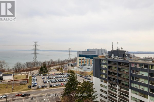 Waterfront view with hospital, high-voltage towers, and apartment buildings - 1402 - 442 Maple Avenue Burlington