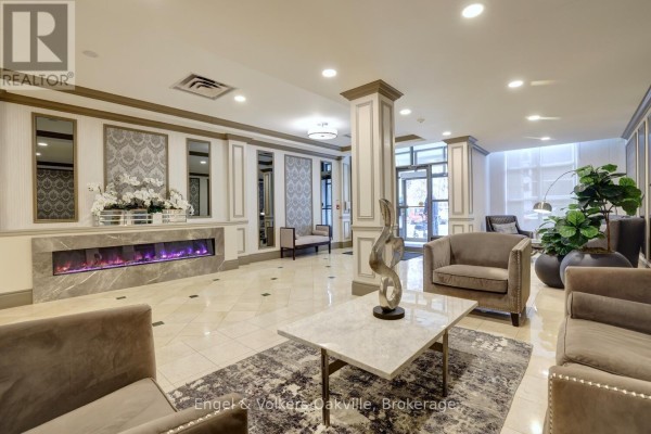 Lobby with electric fireplace and modern seating - 1402 - 442 Maple Avenue Burlington