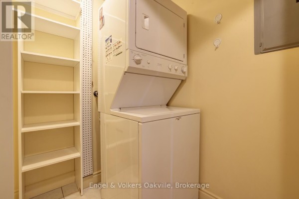Stacked washer and dryer, white shelving, pegboard - 1402 - 442 Maple Avenue Burlington