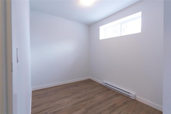 Another angle of the living room with a view of the entrance and natural light. - 1402 Pacific Avenue, Winnipeg