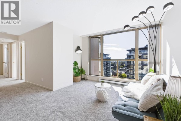 Living room with grey carpet, large window with a view, and a blue sofa. - 1403 8171 Saba Road, Richmond