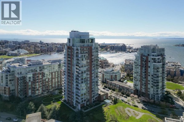 Aerial view of three modern high-rise apartment buildings by the water. - 1404 83 Saghalie Rd, Victoria