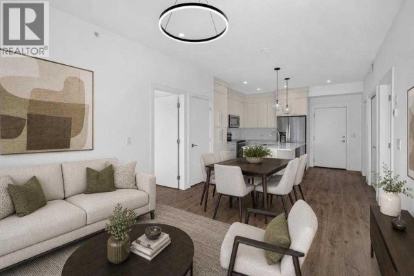 Living and dining area with sectional sofa, dark wood dining table, and view of the kitchen. - 1405, 681 Savanna Boulevard Ne, Calgary