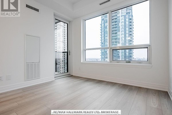 Corner room with large windows offering city views and a glass door. - 1405 - 36 Elm Drive W, Mississauga