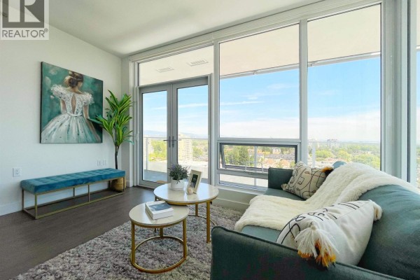 Living room with a teal sofa, plush rug, marble-top coffee tables, and large windows. - 1407 6328 No. 3 Road, Richmond