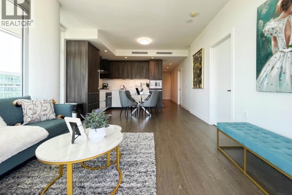 View of the living area, dining space, and modern kitchen with dark wood cabinetry. - 1407 6328 No. 3 Road, Richmond