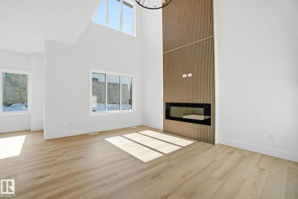 White hallway with a white door featuring a glass panel leading to the exterior. - 1407 Osprey Co Nw, Edmonton