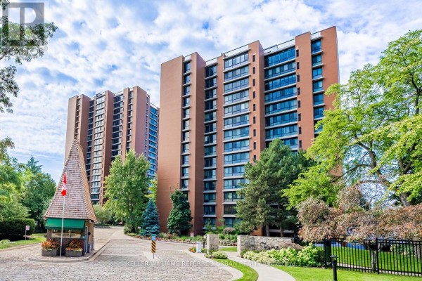 Outdoor swimming pool area with lounge chairs and umbrellas next to a building. - 1409 - 1400 Dixie Road, Mississauga