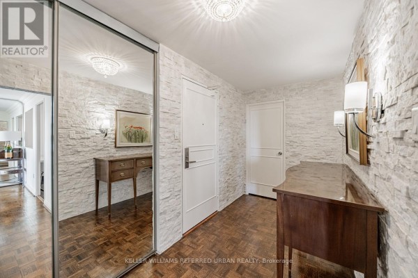 Bathroom with a tiled shower, toilet, dark vanity, and a large mirror. - 1409 - 1400 Dixie Road, Mississauga