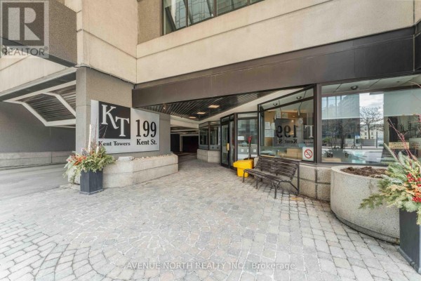 Entrance area of 199 Kent Street, Ottawa, with signage, benches, and decorative planters. - 1409 - 199 Kent Street, Ottawa
