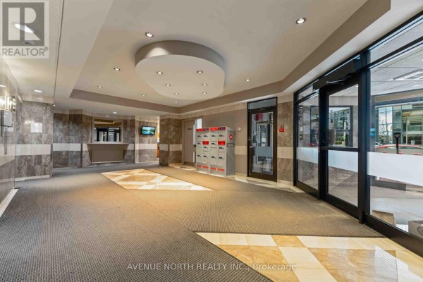 Lobby of 199 Kent Street, Ottawa, featuring carpeted floors, marble accent walls, and mailboxes. - 1409 - 199 Kent Street, Ottawa