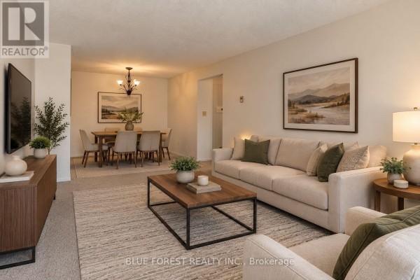 Living and dining area with a sofa, dining table with six chairs, and a chandelier. - 141 - 1096 Jalna Boulevard, London South