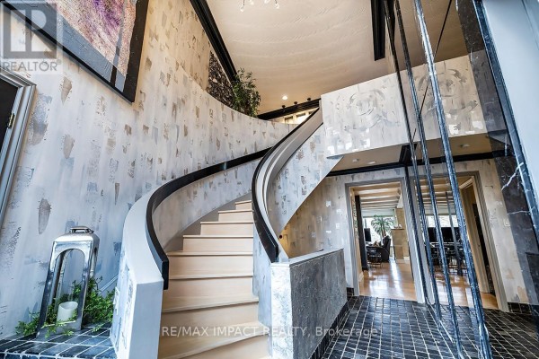 Curved staircase leading to upper level, with marble accents and natural light - 1410 Manitou Drive, Oshawa