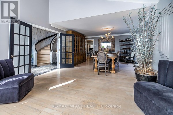 Open dining area with wooden table, stylish chairs, and large windows - 1410 Manitou Drive, Oshawa