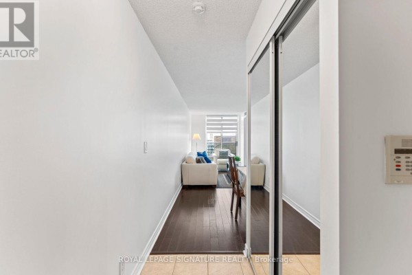 Close-up of the apartment door with wooden frame and lock - 1411 - 212 Eglinton Avenue E, Toronto