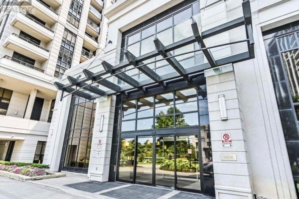 Close-up of the modern glass entrance canopy and automatic doors of the building. - 1414 - 100 Harrison Garden Boulevard, Toronto