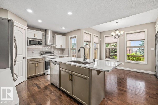 Entryway with grey walls, white trim, and striped area rugs - 1416 56 St Sw, Edmonton