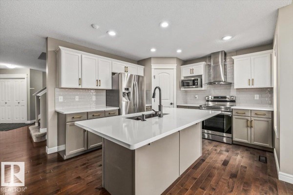 Cozy room with blue accent walls, floral designs, and beige carpet - 1416 56 St Sw, Edmonton