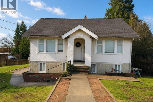 Front view of a small white house with a pitched roof and brick path. - 1416 Eighth Avenue, New Westminster