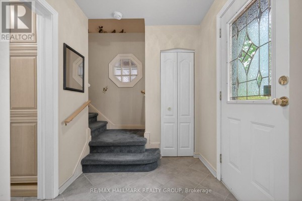 Bedroom with a vaulted ceiling, ceiling fan, large window, and light green walls. - 1416 Woodward Avenue, Ottawa