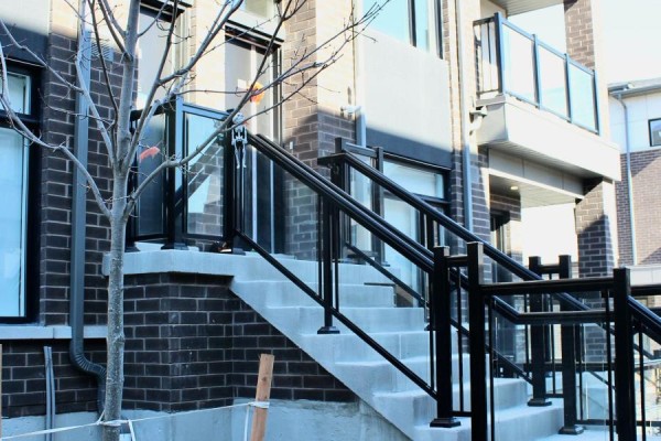 Exterior stairs with glass railings leading to townhouse entrance. - 1419 - 1695 Dersan Street, Pickering