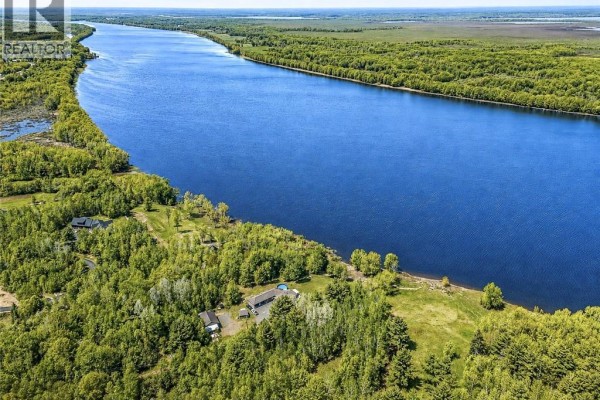 Kitchen with stainless steel appliances, two-toned cabinets, and a granite-topped island with seating. - 1419 102 Route, Upper Gagetown