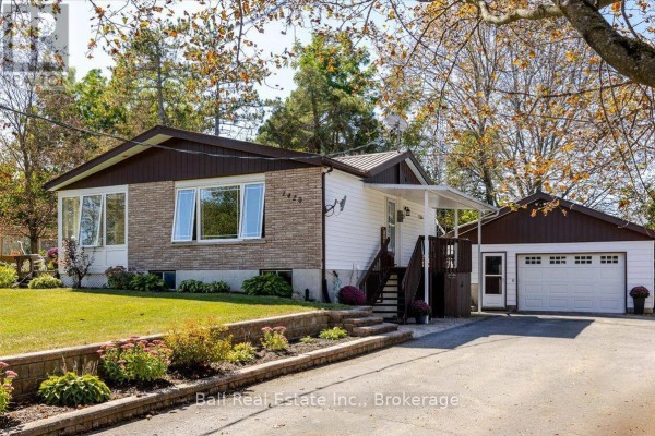 Side view of a bungalow with brick and white siding, an attached garage, and a driveway. - 1420 Eastview Drive, Selwyn