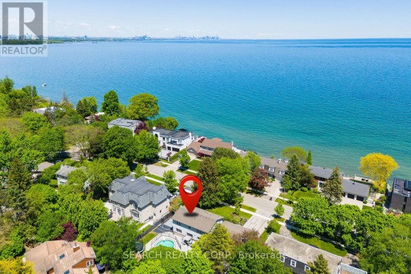 Backyard with artificial turf, a grey shed, flower boxes, and a soccer net. - 1421 Watersedge Road, Mississauga