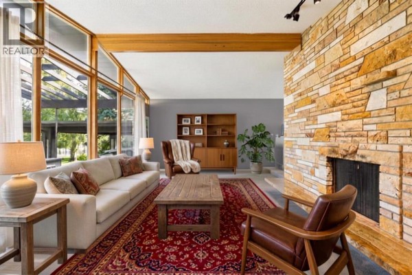 Dining area with a wooden table, chairs, a window, and a view of the backyard. - 1423 75 Avenue Sw, Calgary